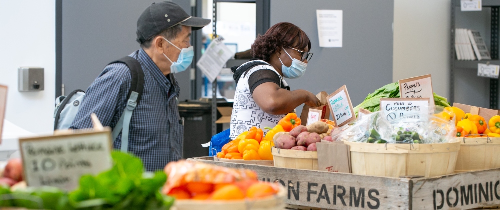 Clients shopping for potatoes and peppers at Daily Bread Food Bank